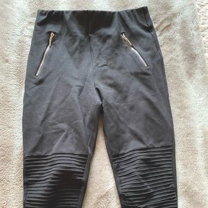 Black leggings with gold zipper pockets